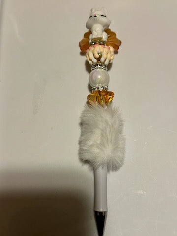 Orange and white fox on fuzzy pen