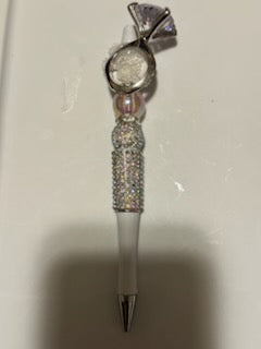 Diamond ring on white pen