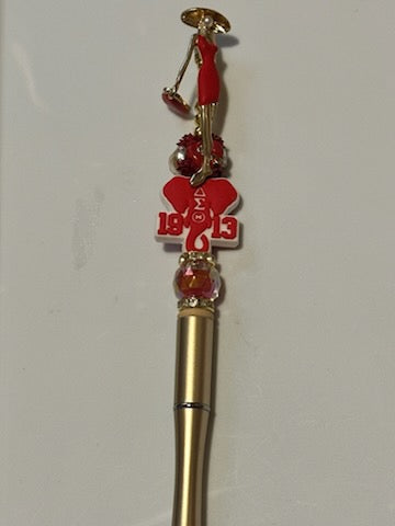 Delta lady on gold pen