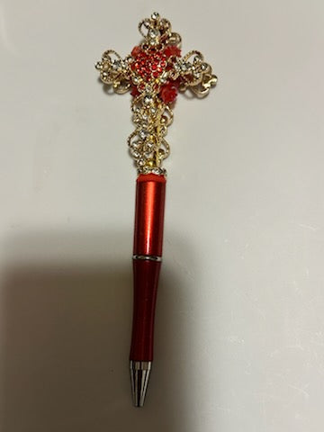 Gold fancy cross on red pen