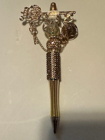 Gold key and charm pen