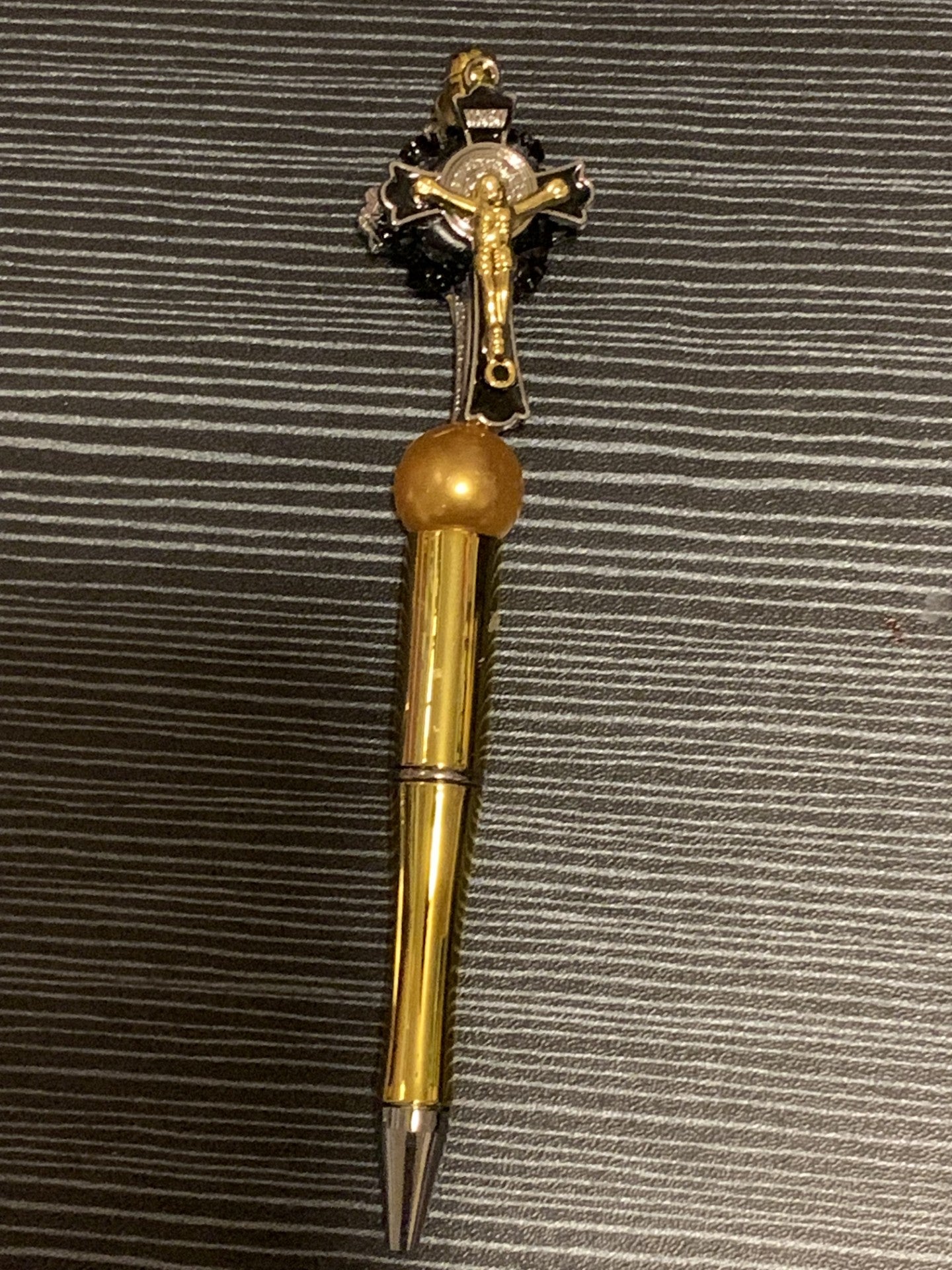 Jesus on a gold cross pen