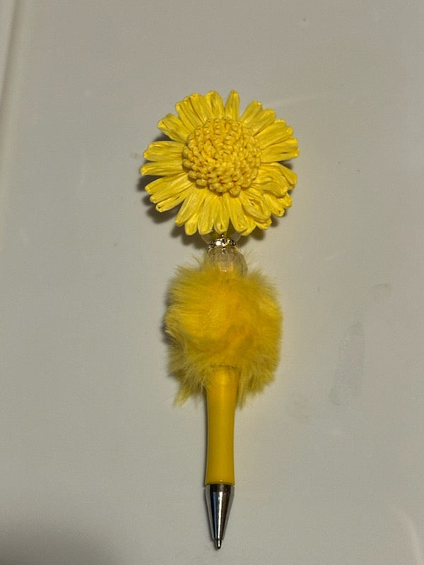 Yellow sunflower on fuzzy yellow pen