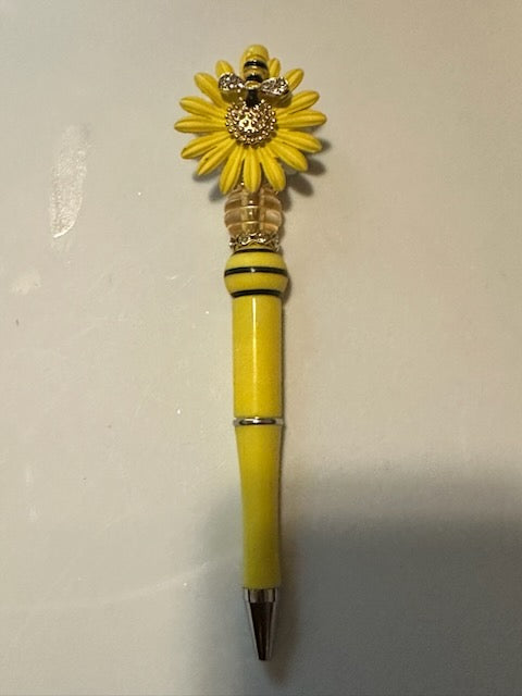 Yellow sunflower with bee pen