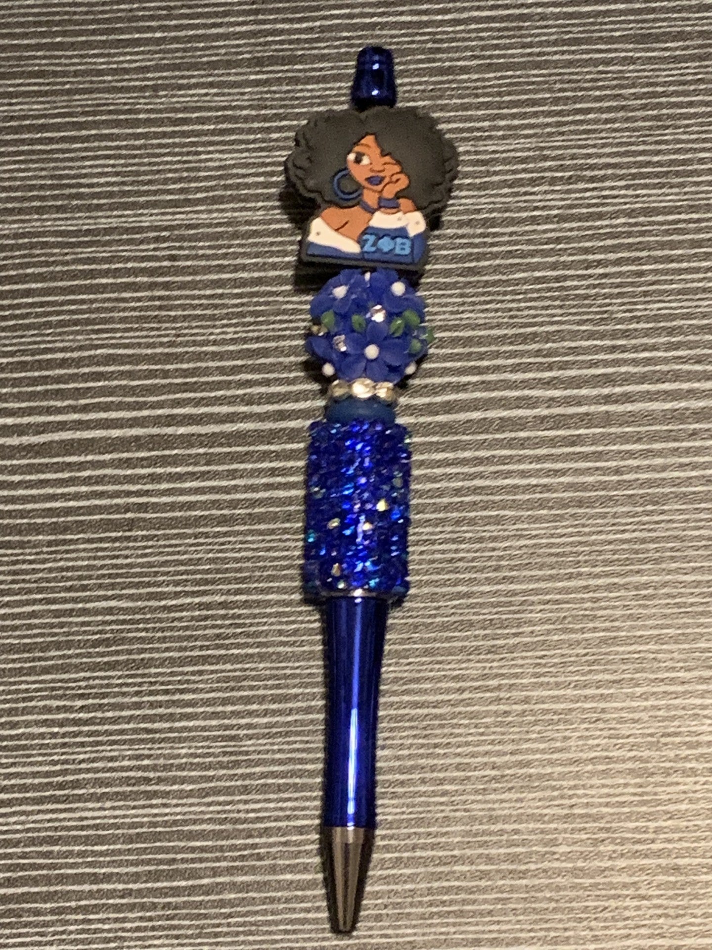 Zeta girl with blue flower on blue sparkle pen